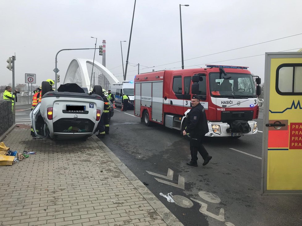 Auto skončilo po nehodě na Trojském mostě na střeše.