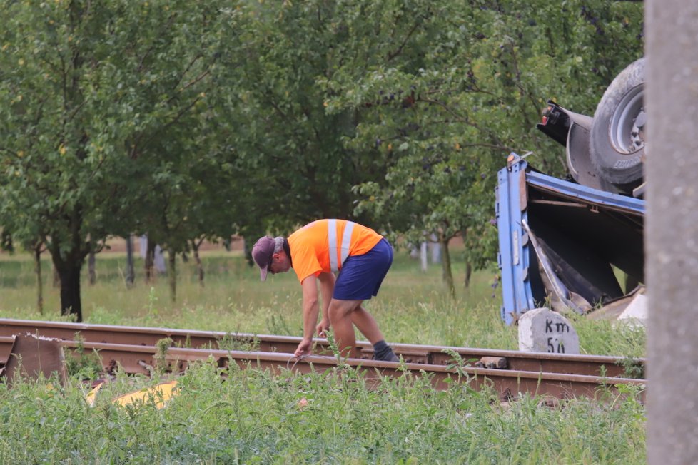 Pracovníci SŽDC zjišťují, jak jsou poškozeny koleje.