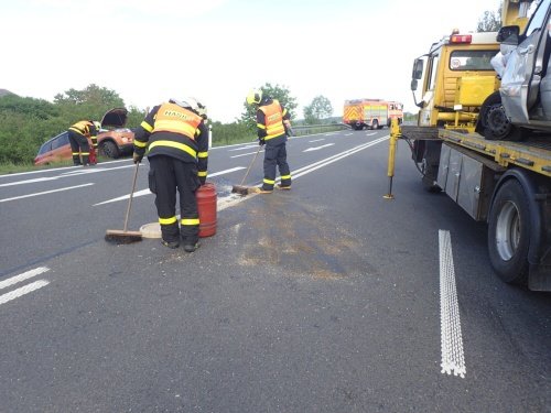 Hasiči museli po nehodě zasypat vozovku sorbentem kvůli uniklým kapalinám.