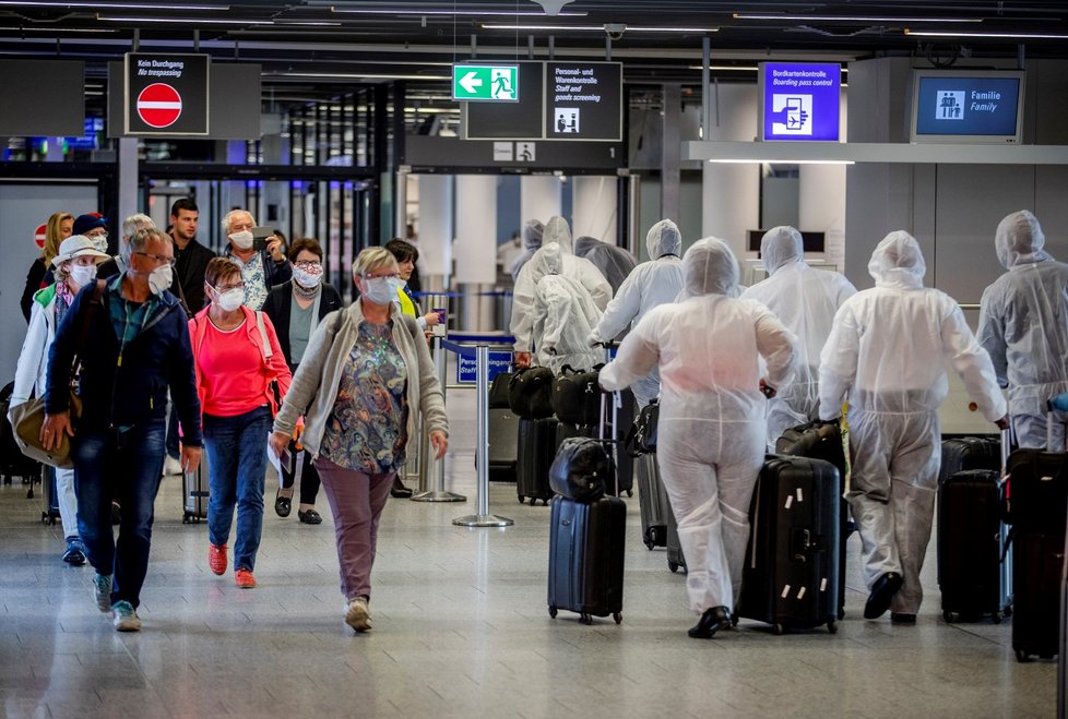 Posádka South African Airways na letišti v německém Frankfurtu míjí další cestující (18. 4. 2020)