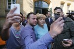 Kancléřka Angela Merkelová s běženci (archivní foto)