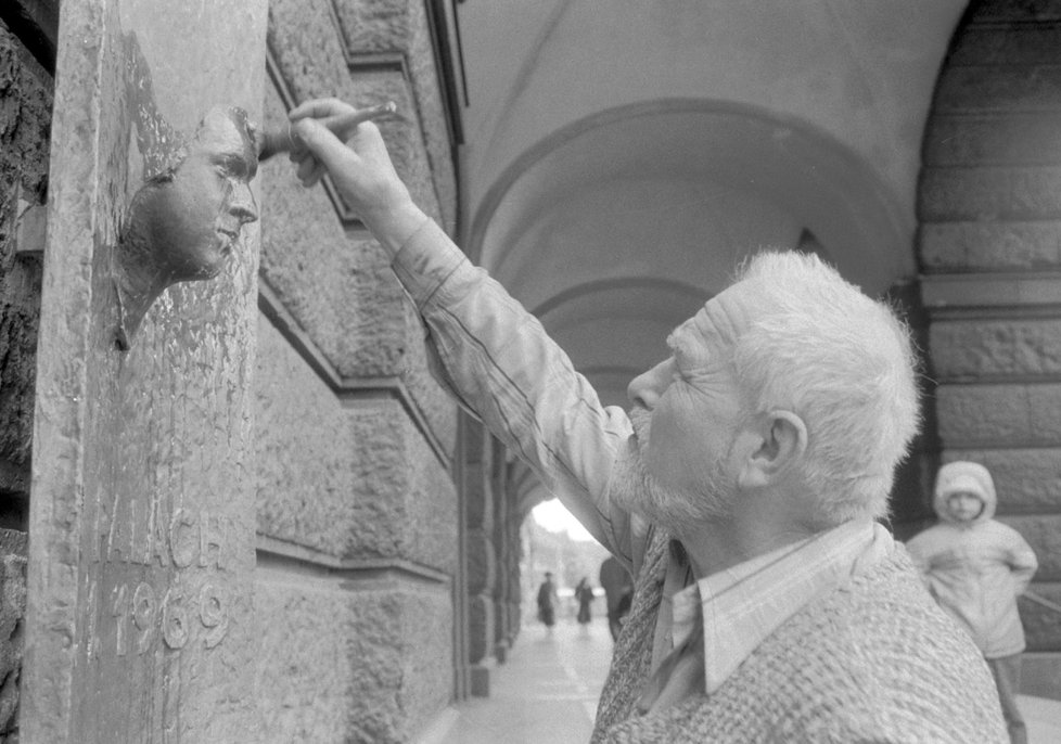 Posmrtná maska Jana Palacha na budově filozofické fakulty a její tvůrce – akademický sochař Olbram Zoubek.