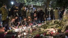 Lidé uctívají památku padlých po útocích 13. 11. před klubem Bataclan.