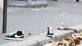 Boty a krev, pozůstatky po pátečních teroristických útocích v ulicích Paříže poblíž klubu Bataclan.