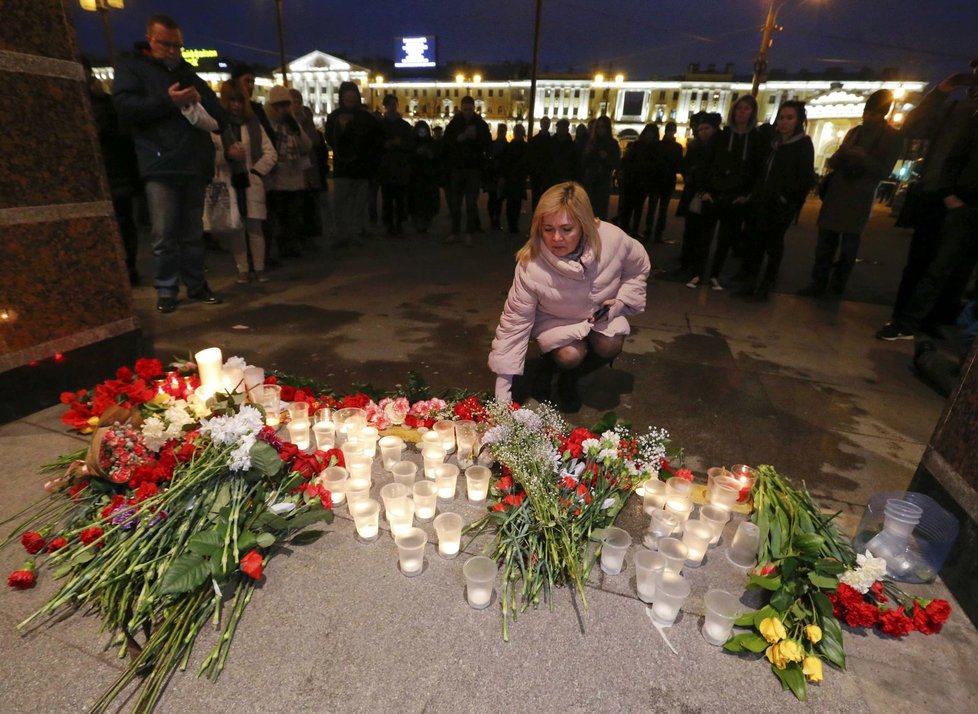 Lidé nosili poblíž místa útoku květiny a zapalovali svíčky.