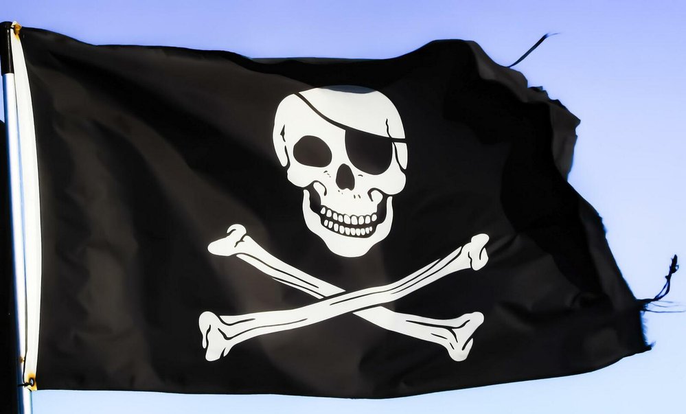 Slavný pirátský symbol: Lebka a zkřížené hnáty