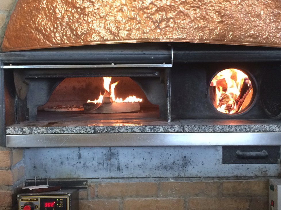 Pizzy v peci jsou hotové do několika minut. Může za to konstantní teplota 300° C, kterou v Pizzerii Pepe Nero udržují pomocí dřeva i plynu.