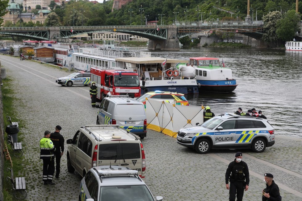 Hasiči spolu s policisty pátrají u Čechova mostu v centru Prahy po muži, který z mostu skočil (30. 5. 2021).
