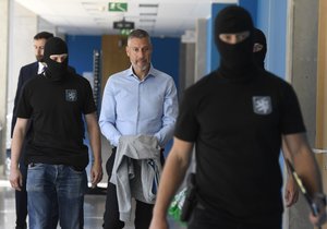 Police officers take away lobbyist Michal Redl at the court, which decided on custody for the accused in the case of corruption in the Prague transport company, June 17, 2022, Prague.