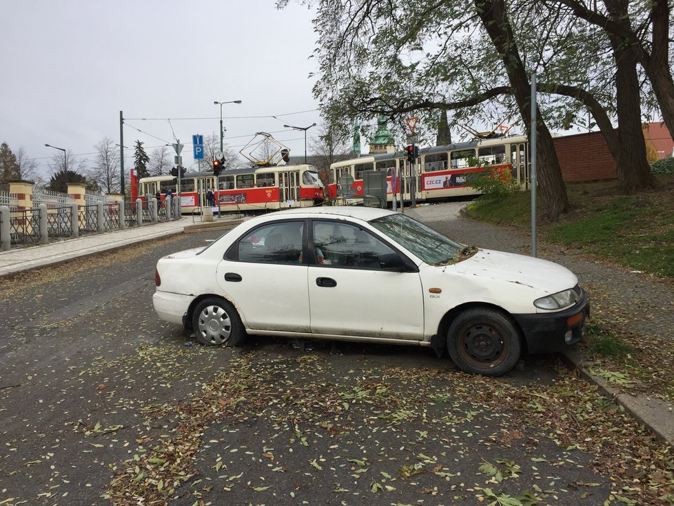 Jen několik metrů od Pražského hradu stojí vrak automobilu.