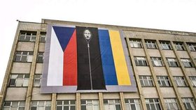 Symbol vzniku ČSR i ukrajinské odhodlanosti? Na budově resortu vnitra visí vlajka s vytrácejícím se Putinem.