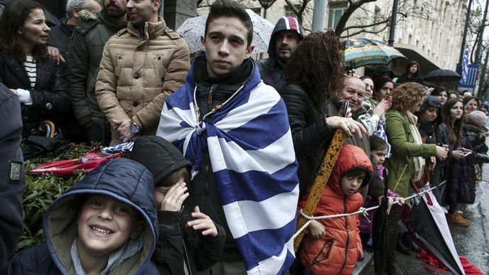 Řekové sledují vojenskou přehlídku v Aténách.