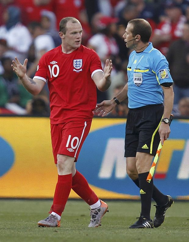 Wayne Rooney ukazuje sudímu: takhle daleko byl míč za brankovou čarou. Wayne Rooney ukazuje sudímu: takhle daleko byl míč za brankovou čarou.