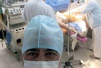 Doktor si odskočil od porodu, aby si vyfotil selfie s rodící mámou za zády