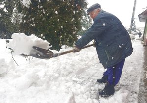 Pavel Luchava (82) odklízí sníh, přestože má problémy se zády. odhazuje ho i s nasazeným krunýřem.