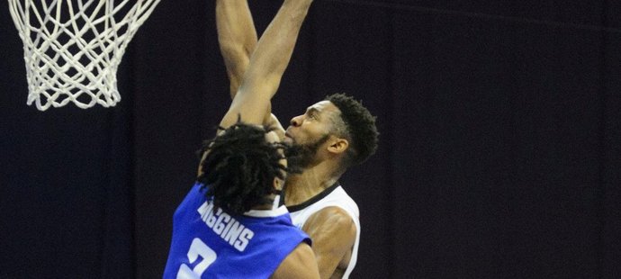 Nymburský Chasson Randle smečuje přes Alana Wigginse z BK Ventspils v úvodním zápase nadstavbové části poháru FIBA