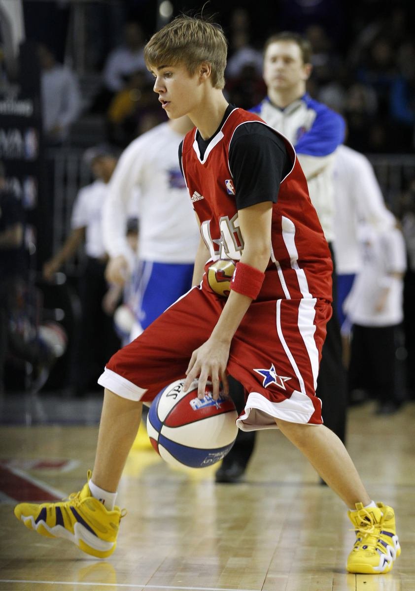 Justin Bieber si prohazuje míč mezi nohama před zápasem celebrit na All Stars víkendu NBA