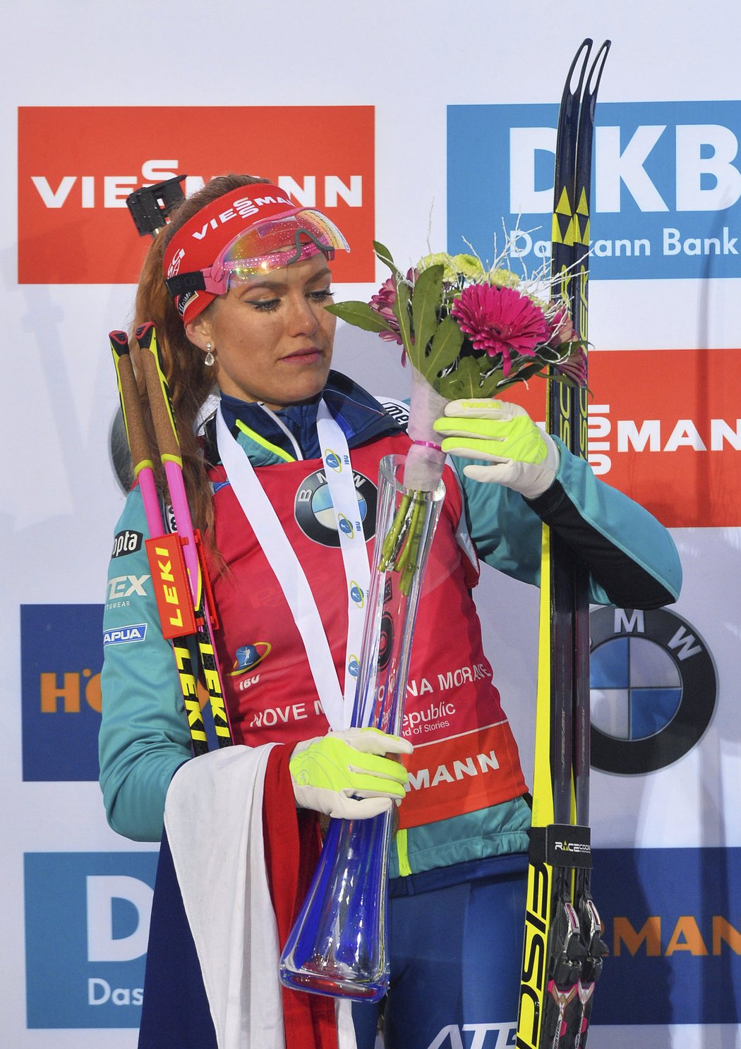 Gabriela Koukalová pózuje po vyhraném závodě s medailí a květinou