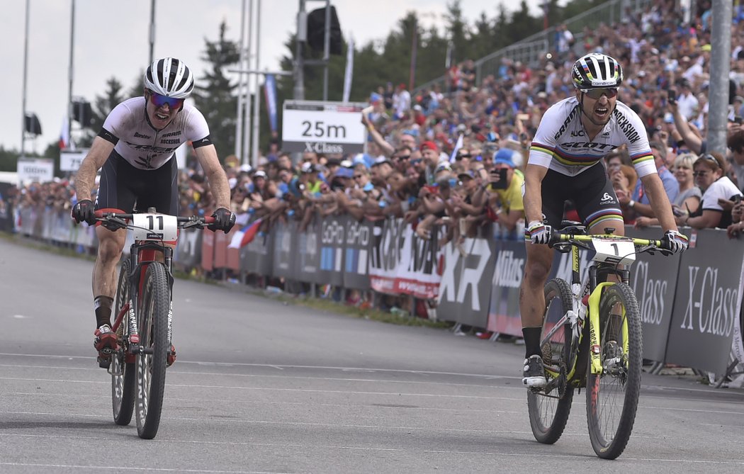 Vlevo druhý novozélandský reprezentant Anton Cooper, vpravo vítěz Nino Schurter ze Švýcarska v cíli závodu SP v Novém Městě