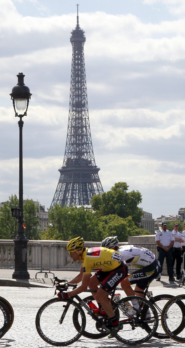 Cadel Evans projíždí ulicemi Paříže poblíž Eiffelovy věže