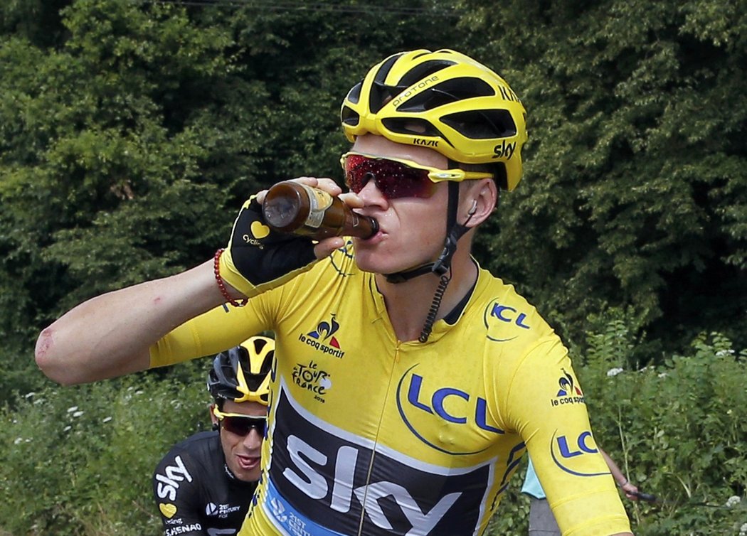 Vedoucí závodník Tour de France Chris Froome si připíjí z lahvičky piva v poslední etapě