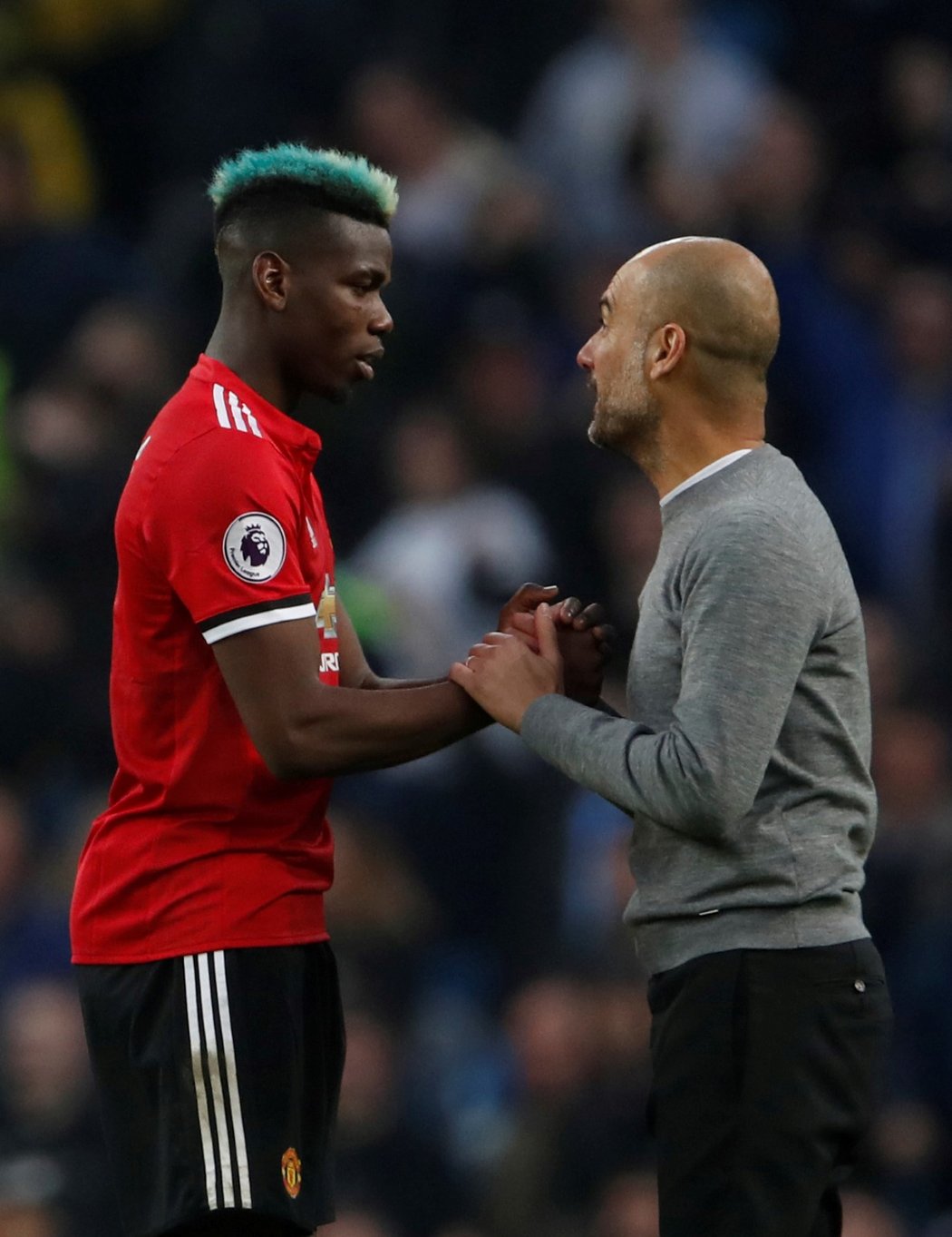 Záložník Manchesteru United Paul Pogba a trenér Manchesteru City Pep Guardiola se zdraví po utkání