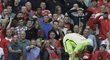 Gólman Manchesteru City se sklání nad kapitánem United Waynem Rooneyem během derby v Premier League.