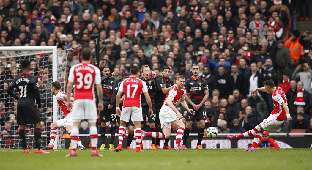 Záložník Arsenalu Mesut Özil střílí gól v utkání Premier League s Liverpoolem.