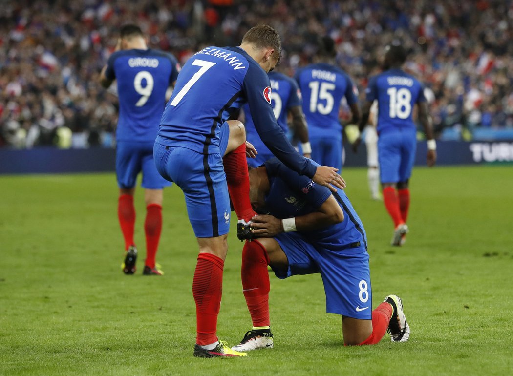 Dimitri Payet oslavuje levačku Antoineho Griezmanna, kterou francouzský útočník vstřelil gól do sítě Islandu