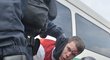 Zkrvavený fanoušek Slavie po zásahu policie na Čechově mostě při pochodu na Letnou