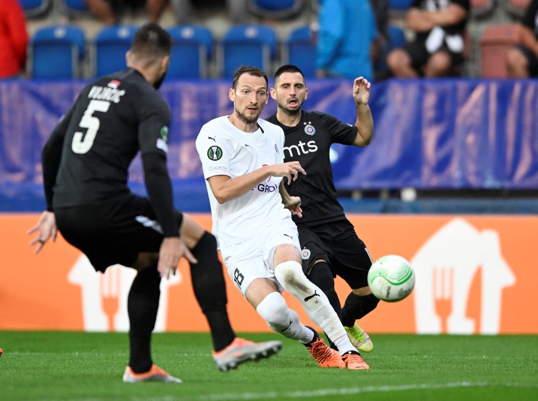 Libor Kozák v souboji o míč v zápase s Partizanem