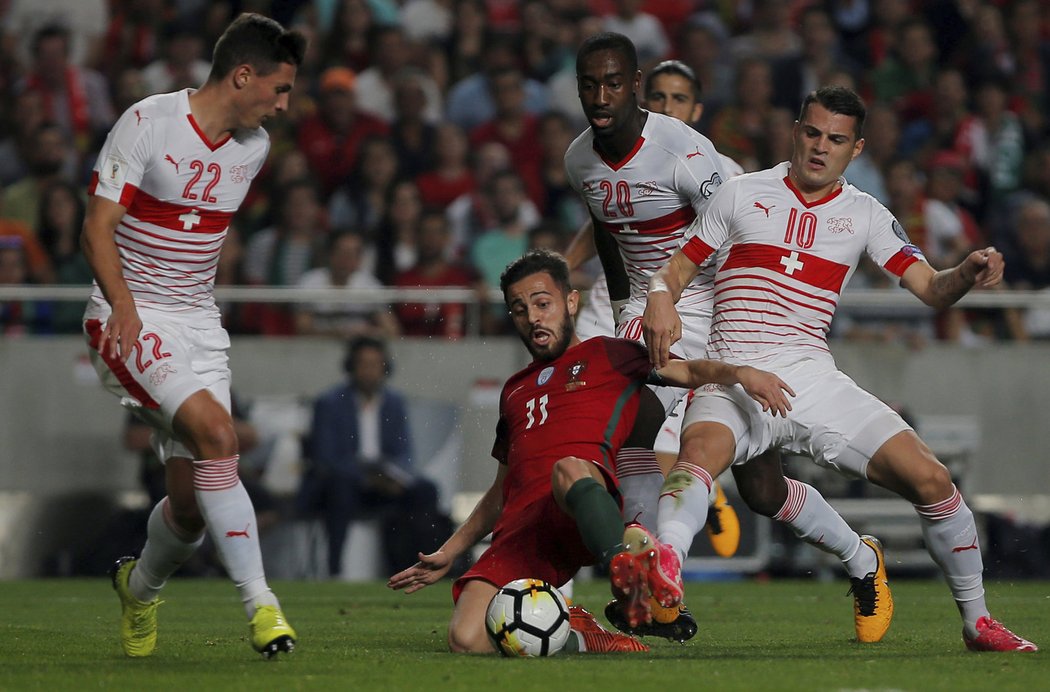 Portugalský záložník Bernardo Silva se snažil uhrát míč v obležení tří švýcarských protihráčů