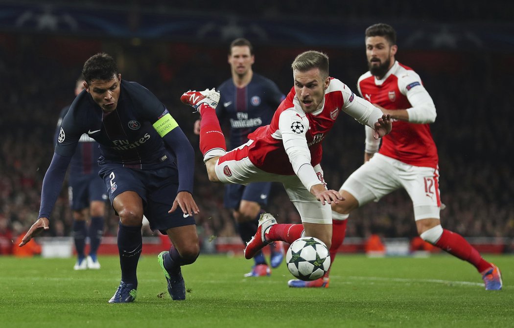 Záložník Arsenalu Aaron Ramsey padá po souboji s kapitánem PSG Thiagem Silvou