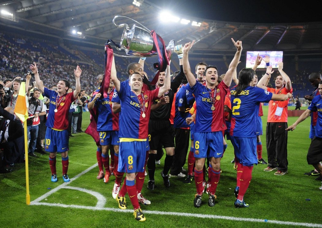 Vítězní fotbalisté Barcelony krouží po stadionu s trofejí.