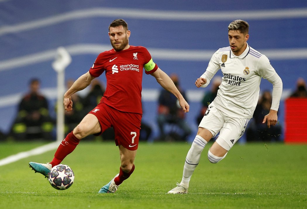 James Milner vyváží míč, stíhá ho Federico Valverde