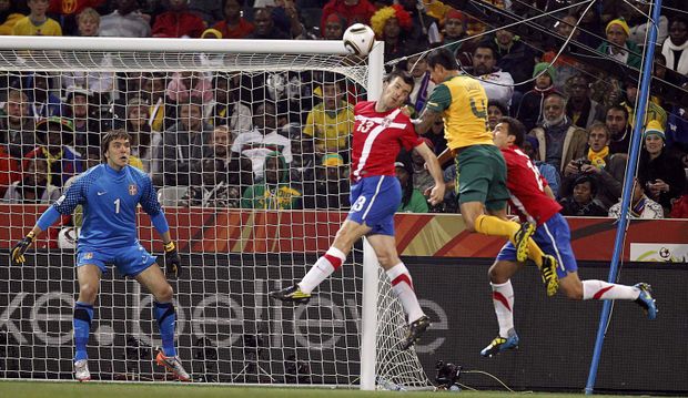 Tim Cahill v hlavičkovém souboji s Aleksanderem Lukovičem. Tim Cahill v hlavičkovém souboji s Aleksanderem Lukovičem.