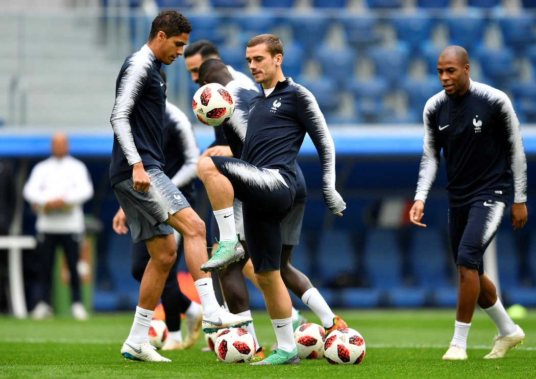 Raphaël Varane (vlevo) a Antoine Griezmann (vpravo) během tréninku francouzské reprezentace před zápasem s Belgií