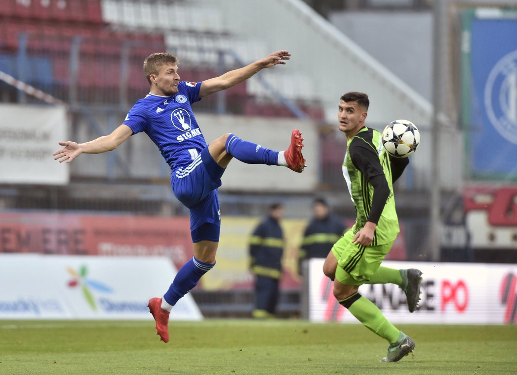 Olomoucký Jiří Texl odehrál míč před Petrem Marešem z Mladé Boleslavi