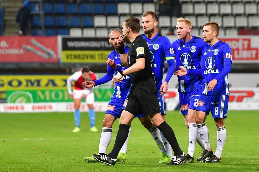 Olomoučtí fotbalisté diskutují s rozhodčím Pavlem Rejžkem v utkání se Slavií