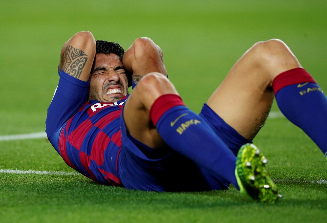 Luis Suárez v bolestech na zemi v utkání Barcelony se Sevillou