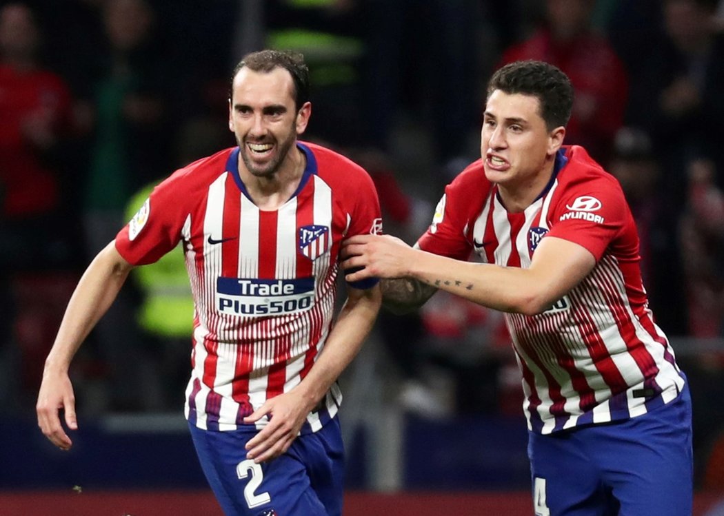 Stoper Atlétika Madrid Diego Godín (vlevo) se raduje se svým spoluhráčem Josém Giménezem z gólu, který vstřelil Gironě