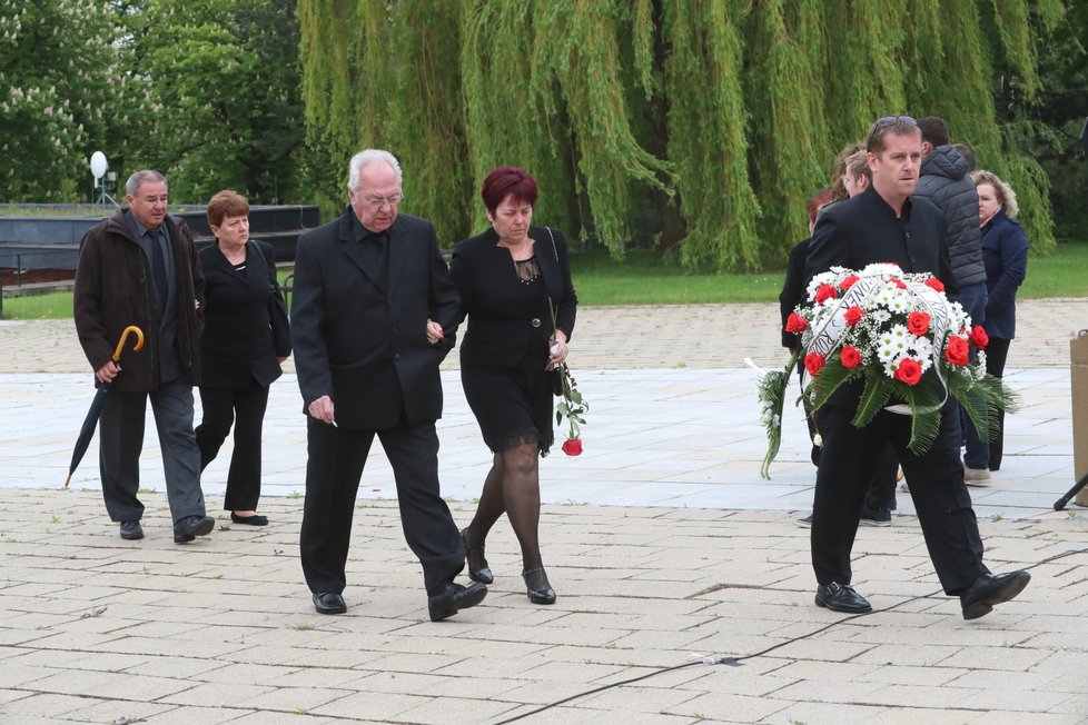 Smuteční hosté nesou květiny na místo posledního odpočinku Josefa Šurala