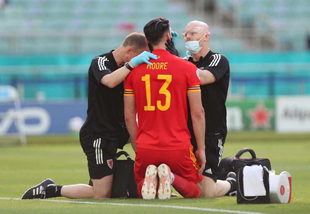 Kieffer Moore z Walesu skončil s tržnou ranou na čele poté, co se hlavou střetl s Kevinem Mbabuem ze Švýcarska