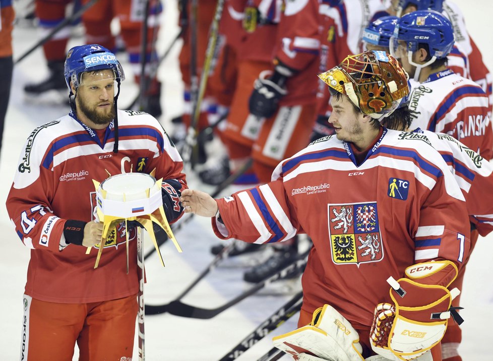 Kapitán Michal Jordán s vítěznou trofejí. Gratuluje mu brankář David Rittich.