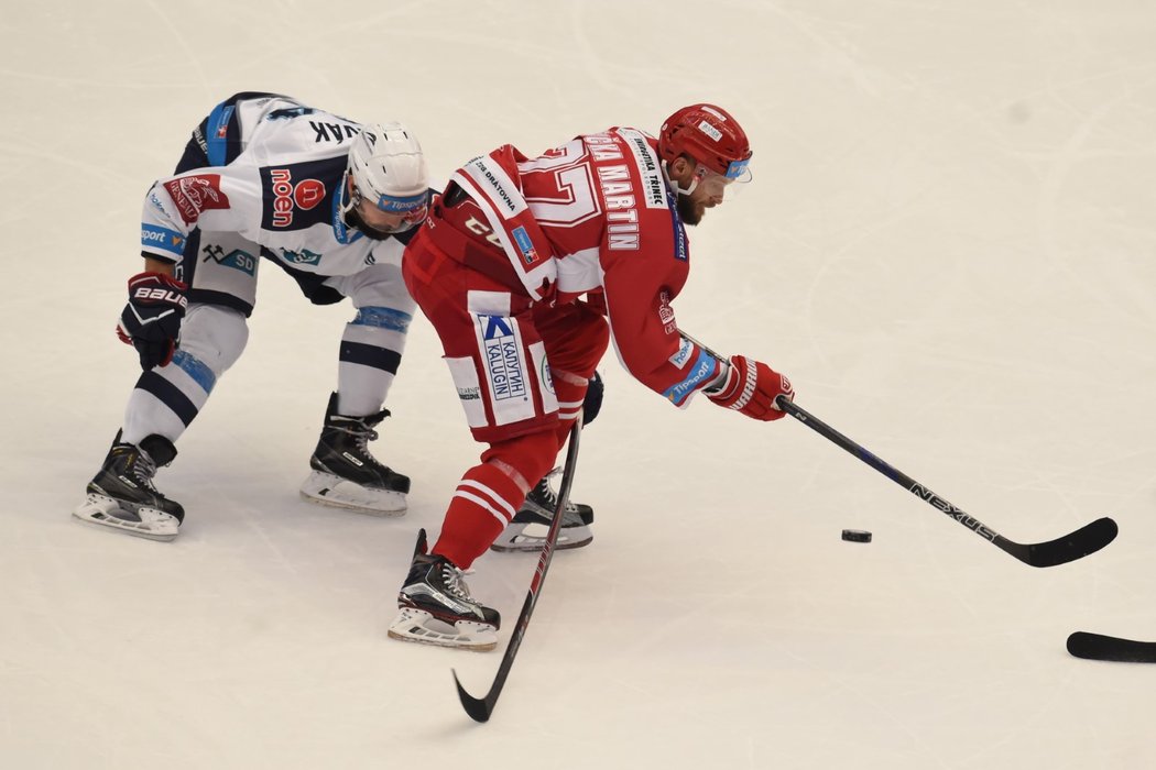 Třinecký střelec Martin Růžička v souboji s chomutovským bekem Tomášem Slovákem