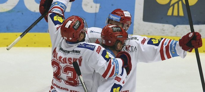 Hokejisté Třince Jiří Polanský, Marcel Hossa a Ján Sýkora se radují z gólu v zápase proti Hradci