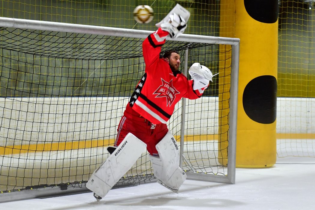 Bývalý reprezentační gólman Ondřej Pavelec v hokejové výstroji chytá fotbalové míče