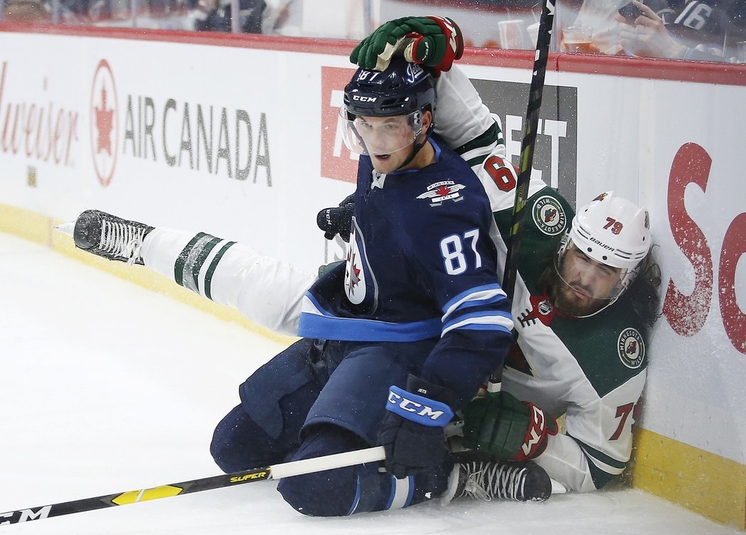 Kristian Reichel v přípravném zápase Winnipegu proti Minnesotě, za hlavu ho drží Hunter Warner