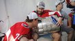 Michal Kempný drží Stanley Cup, políbit ho stihl jeho parťák z obrany John Carlson