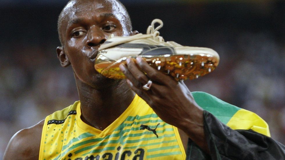 Usain Bolt se svou vítěznou zlatou botou